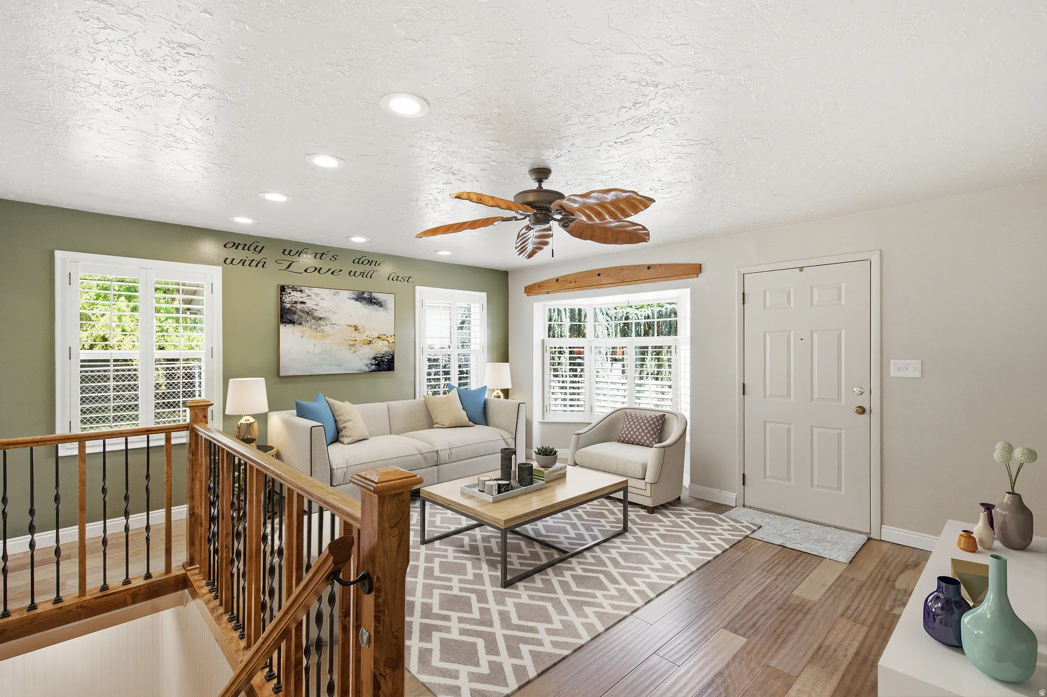 Living area featuring wood-finish flooring, recessed lighting, and a decorative ceiling fan