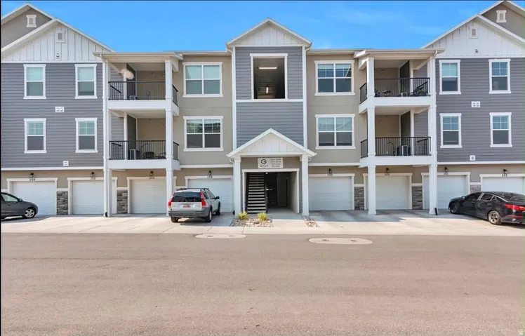 Multi-story condominium building featuring a contemporary design with varied siding textures