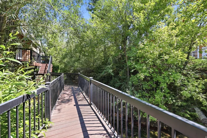 Expansive exterior decking with dark composite boards and black metal railings