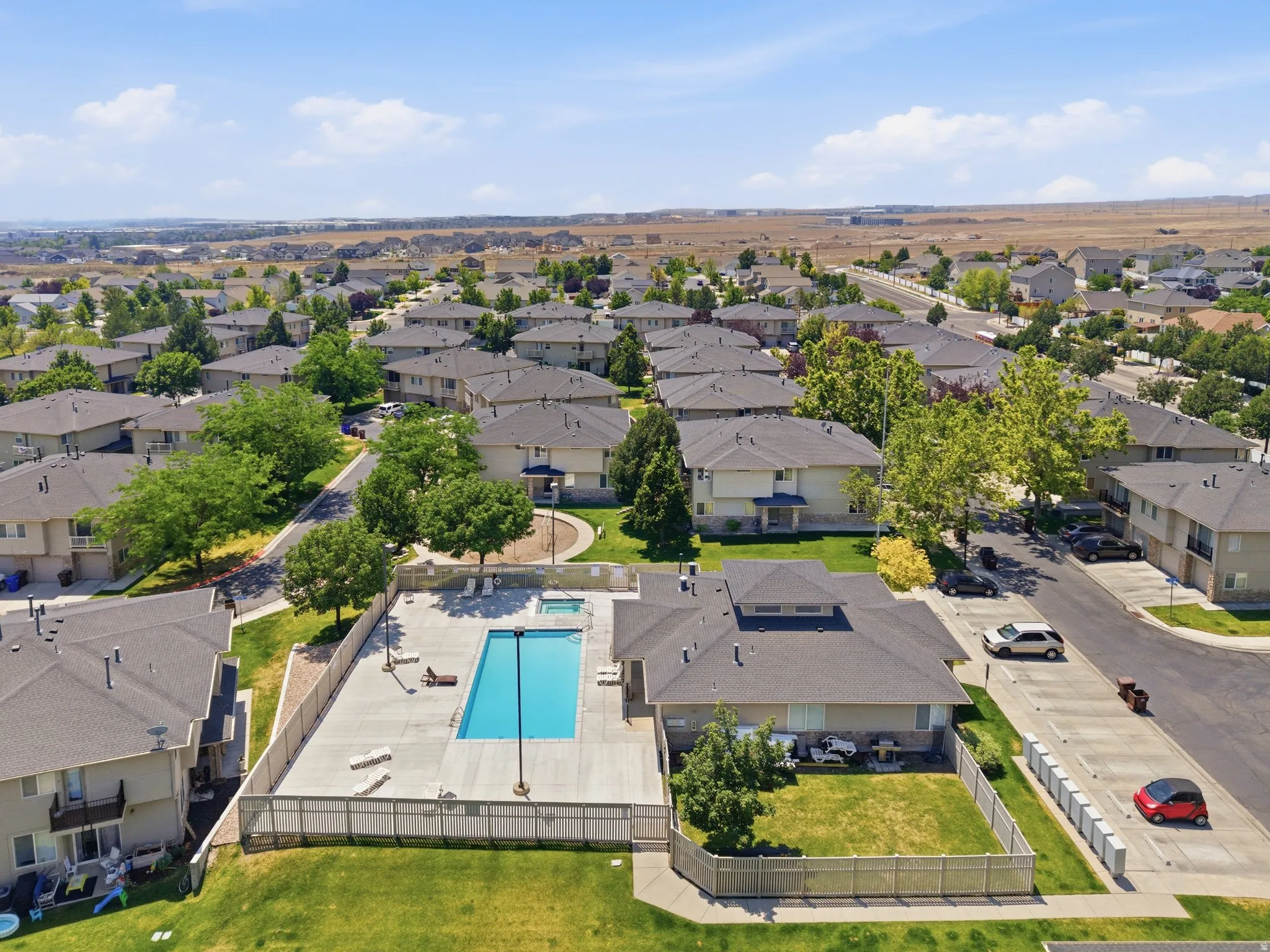 Community features an outdoor swimming pool with an adjacent spa, surrounded by concrete decking and a privacy fence