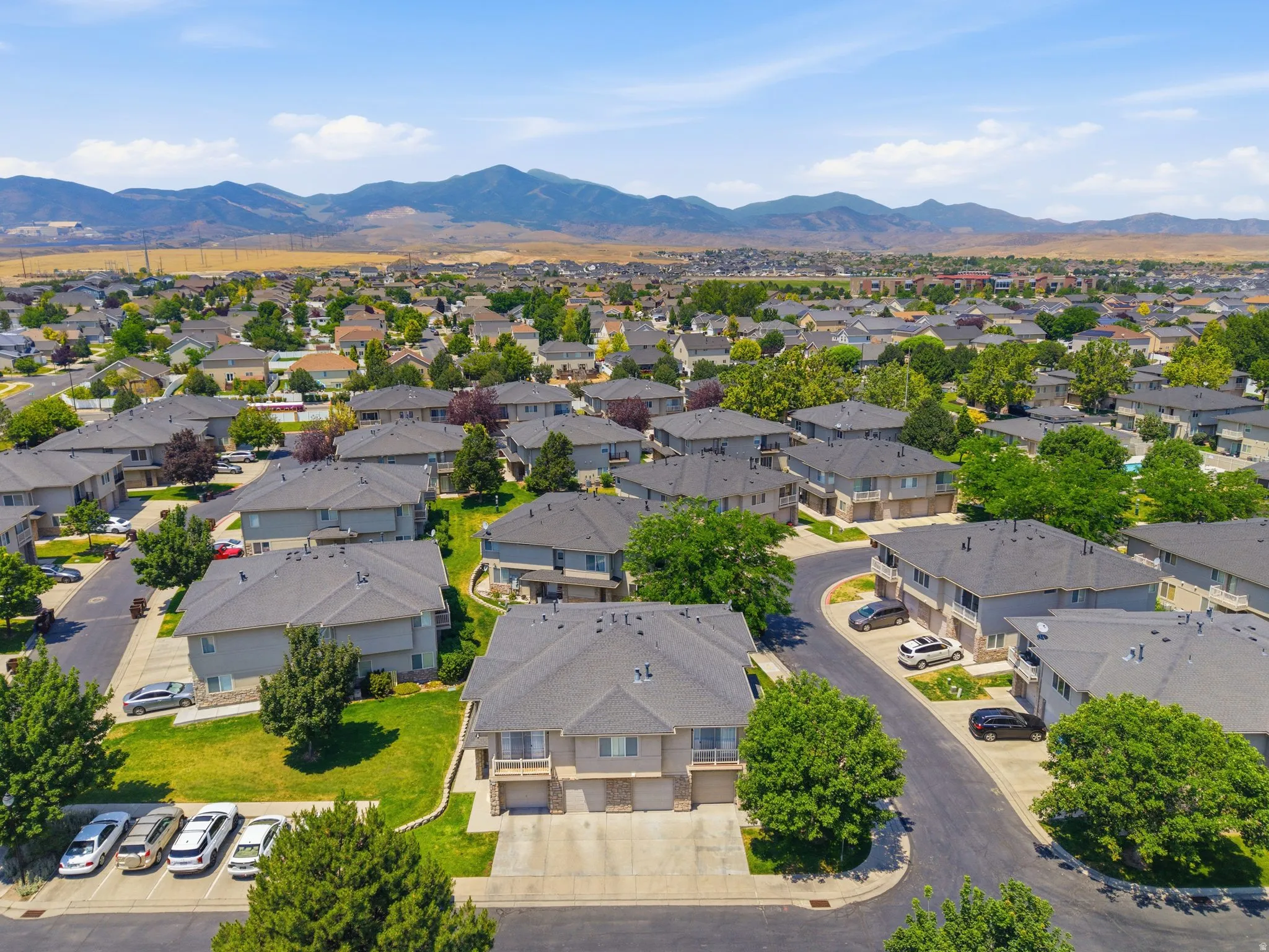 Residential area featuring multiple two-story properties with attached garages and paved driveways