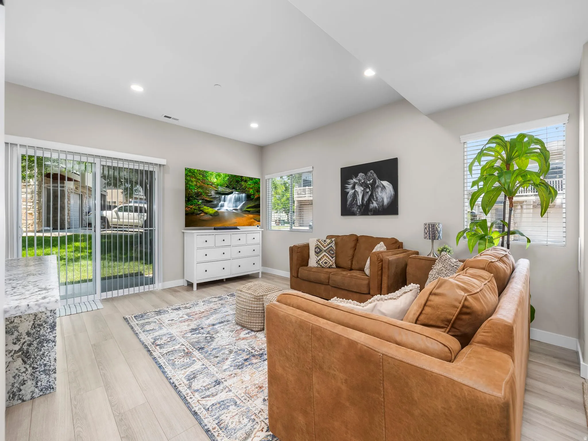 Light wood-finish flooring complements the neutral wall tones