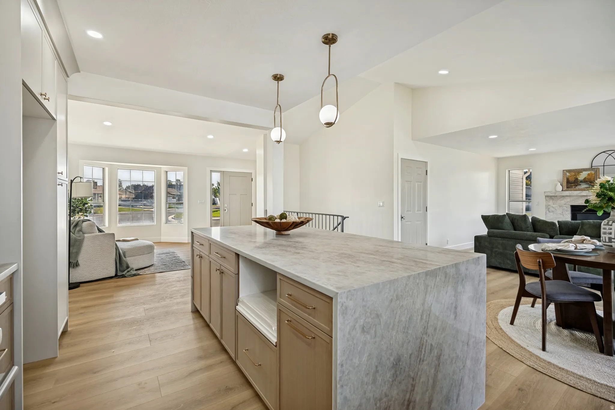 Spacious kitchen island with a light-toned stone countertop and integrated cabinetry