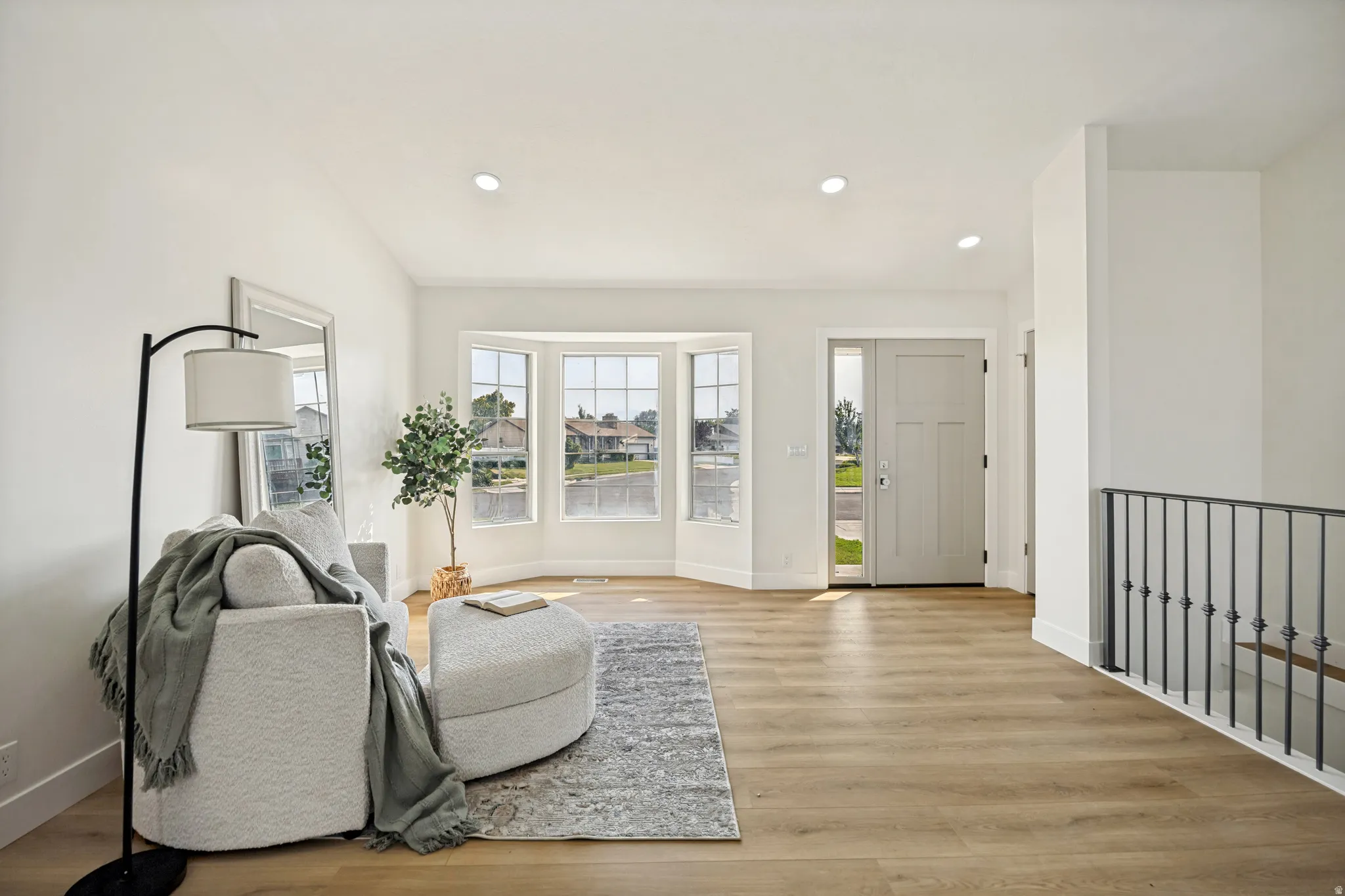 Bright entry space featuring wood-finish flooring and recessed lighting
