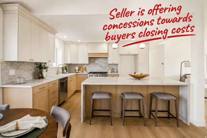Modern kitchen featuring two-tone cabinetry, a central island with bar seating, integrated stainless steel appliances, marble countertops, and light wood-finish flooring