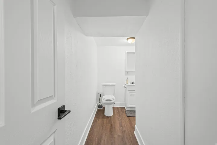 Bathroom featuring wood-finish flooring, white walls, and a recessed ceiling light fixture