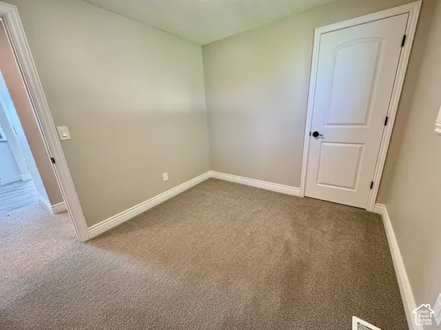 Neutral-toned walls complement plush carpeting