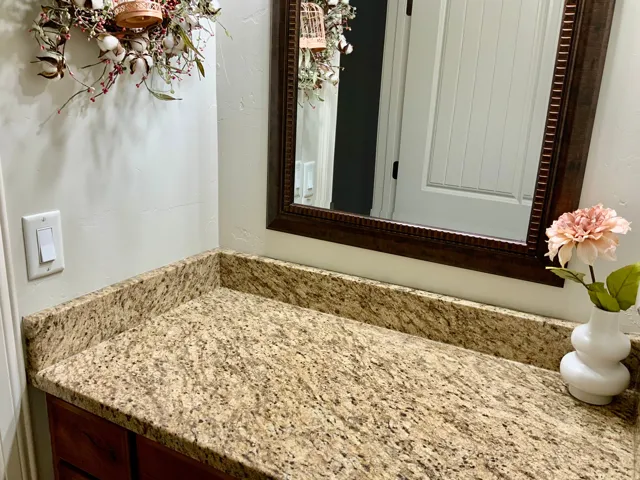 Granite-style countertop with a matching backsplash