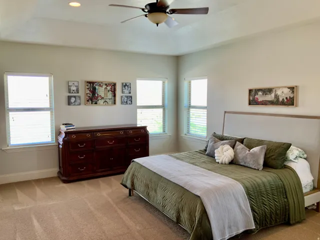 Bedroom featuring multiple windows with blinds, a ceiling fan with integrated lighting, recessed lighting, and carpeted flooring