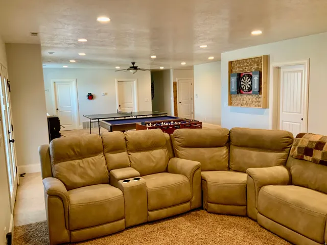 Spacious recreation room featuring recessed lighting and a ceiling fan