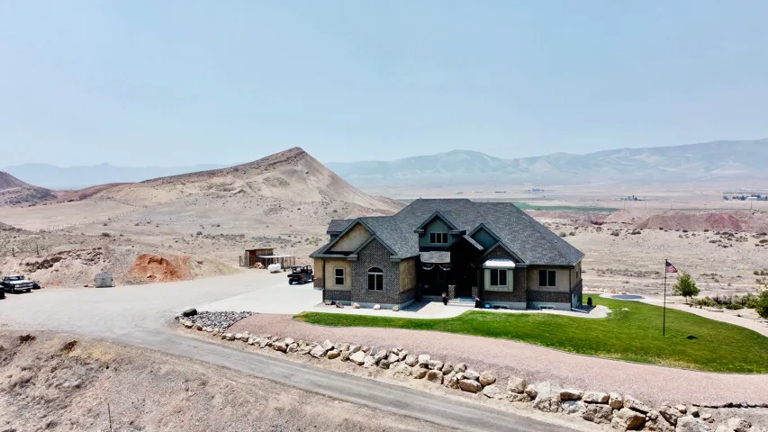 Two-story residence featuring a stone and siding exterior with a dark shingle roof
