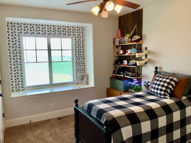 Recessed window with a broad sill and decorative wallpaper surround