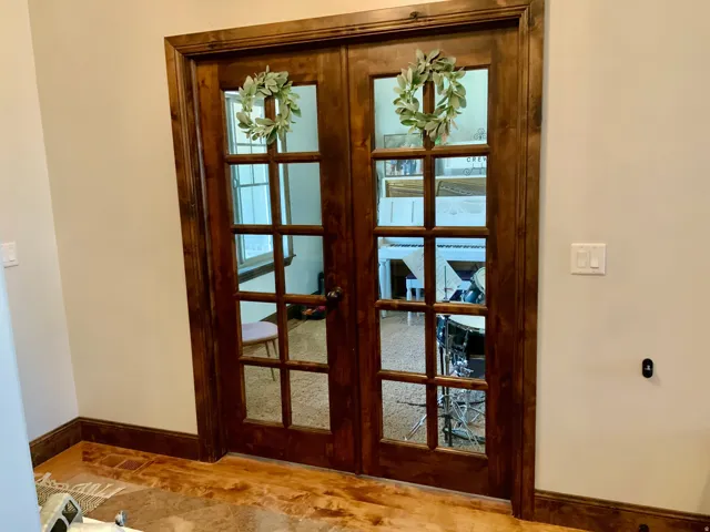 Warm wood-finish French doors with multiple glass panes