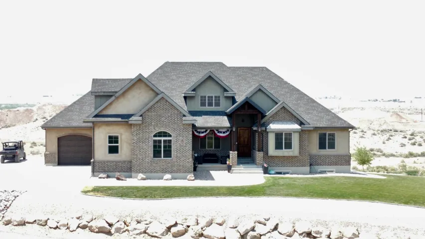 Multi-level property featuring a prominent front entrance with a covered porch