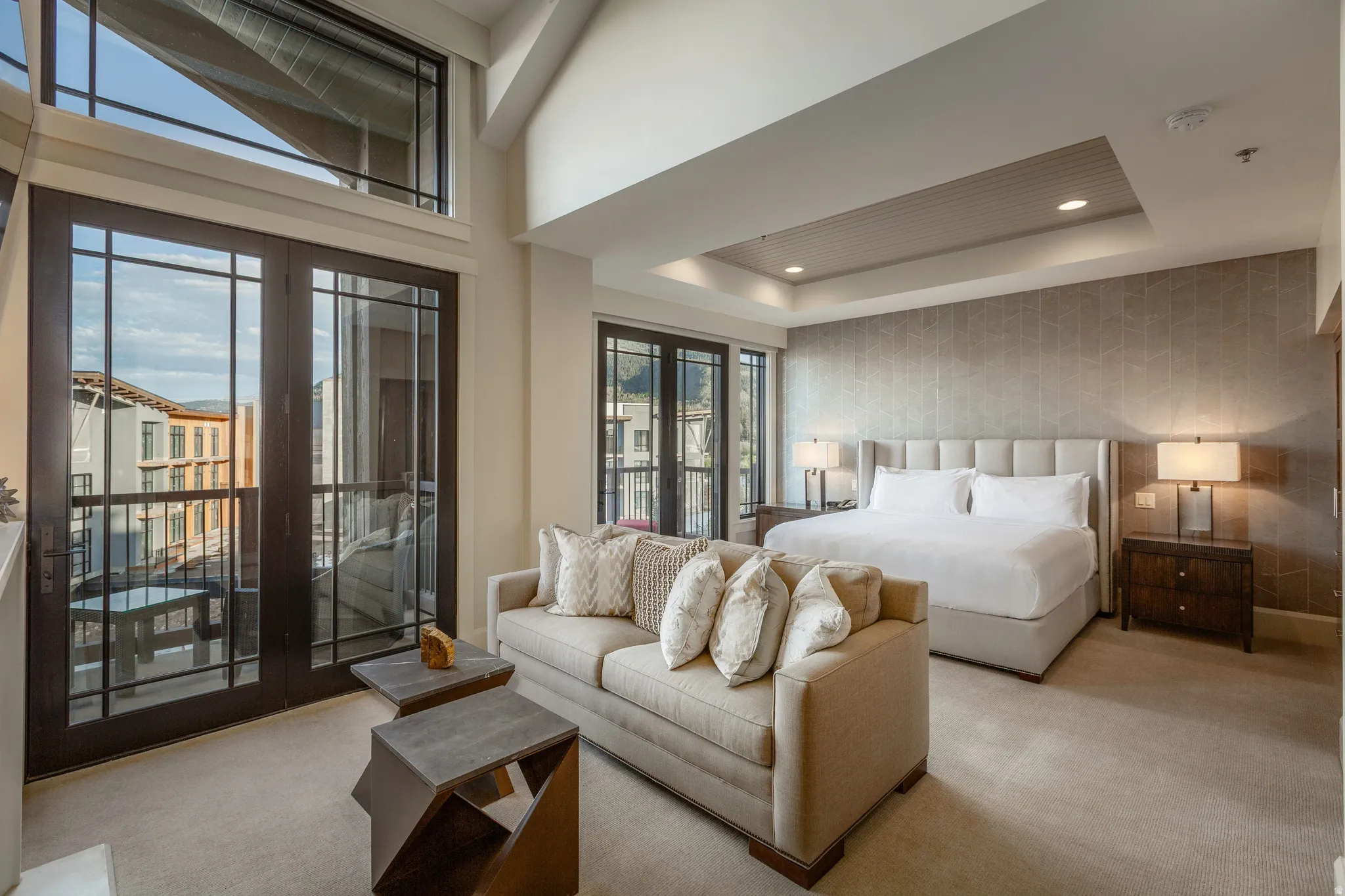 Spacious studio apartment featuring a private balcony with metal railings and a double-door entry