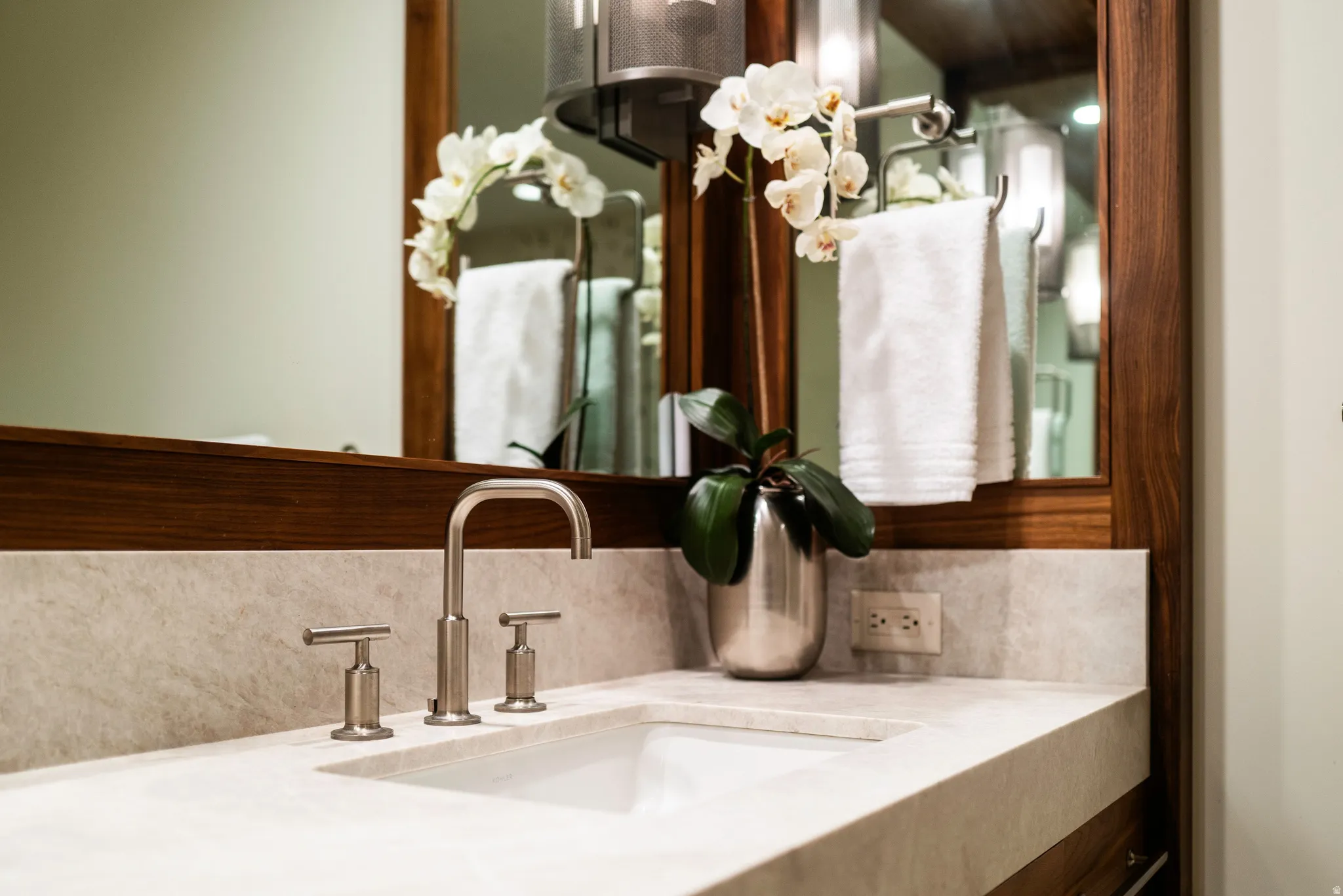 Integrated vanity with a neutral-toned countertop and an undermount sink