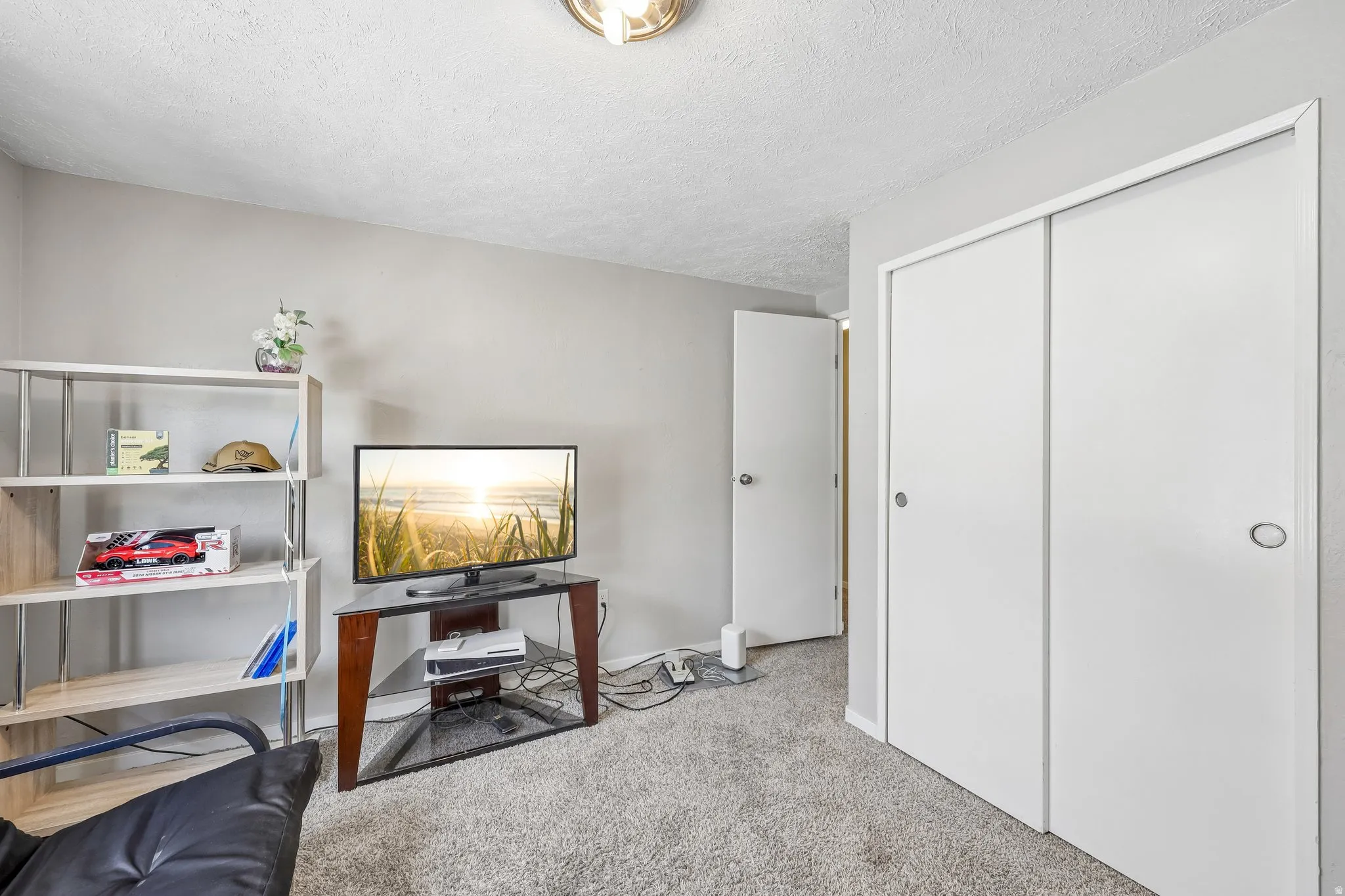 Room featuring gray walls, gray carpet, and a ceiling light fixture