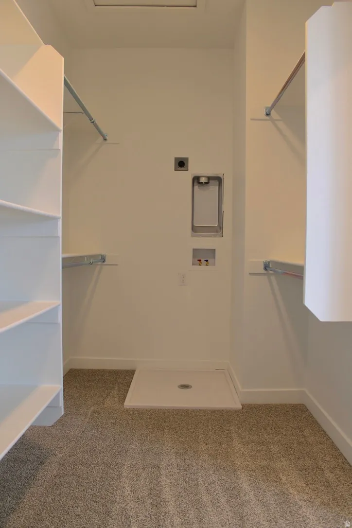 Laundry area featuring a washer hookup, dryer hookup, and a floor drain