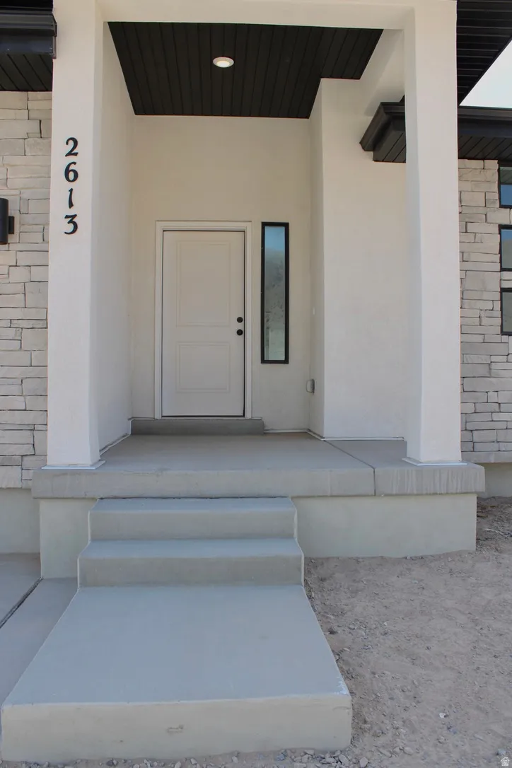 Contemporary entryway featuring a white paneled door, a dark wood-finish ceiling, and a vertical frosted glass window