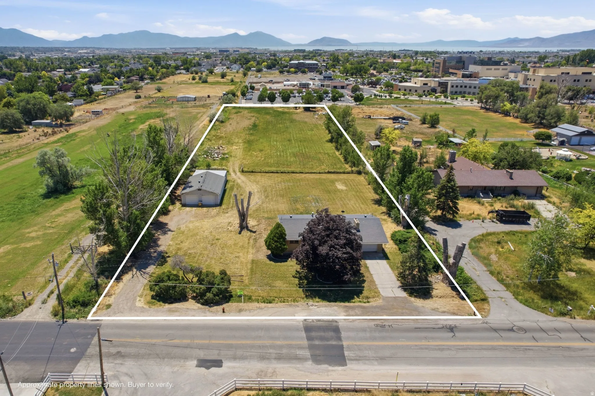Expansive parcel featuring a single-story residence and a detached garage/outbuilding