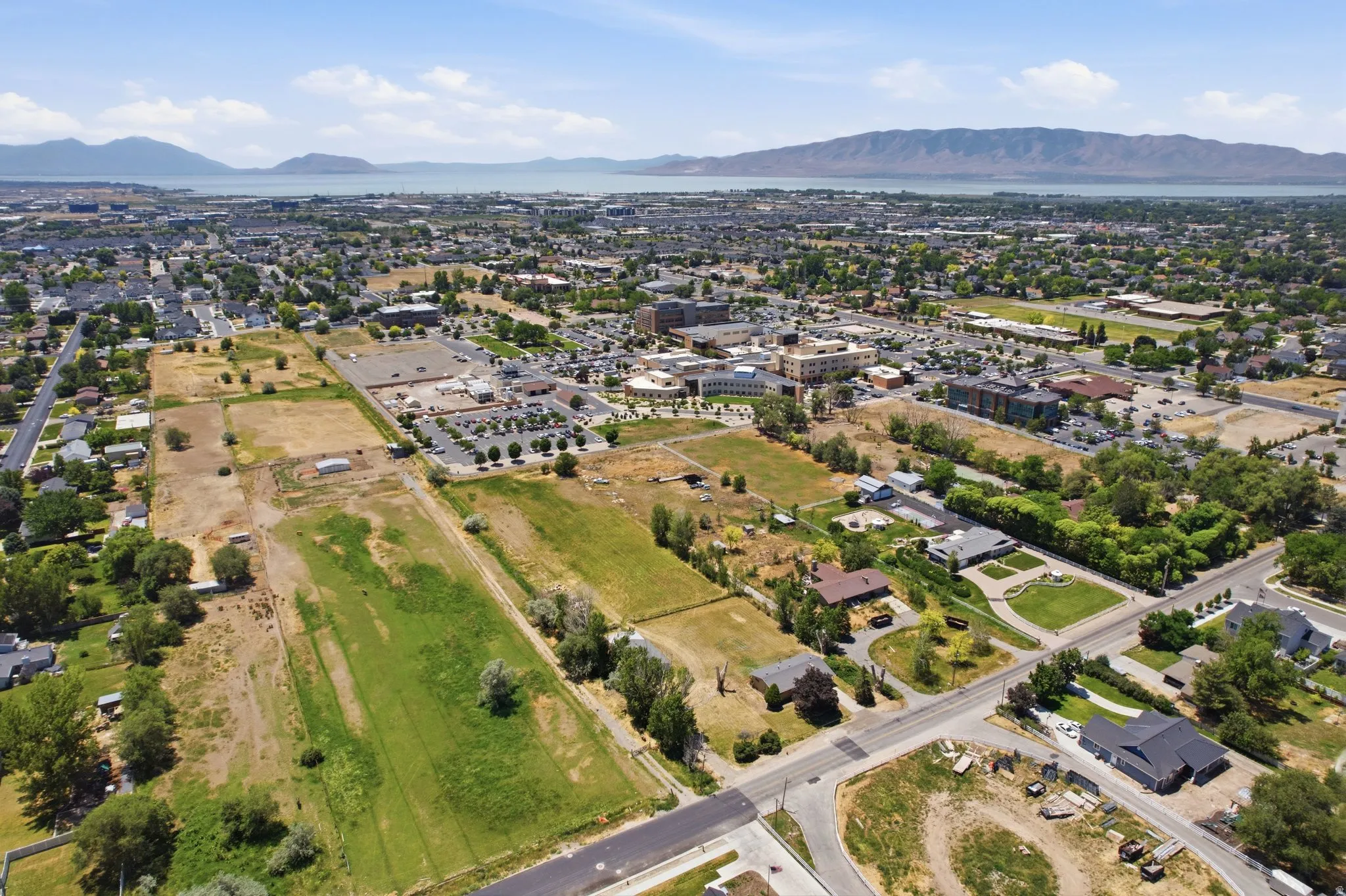 Aerial perspective showcasing a developed community with a prominent body of water and mountains in the background