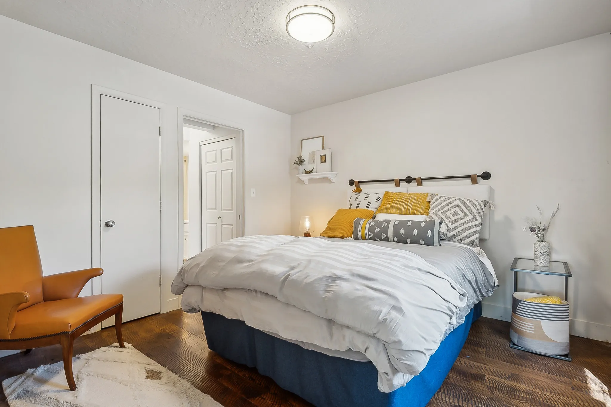 Bedroom featuring wood-finish flooring, white walls, and a recessed ceiling light fixture.