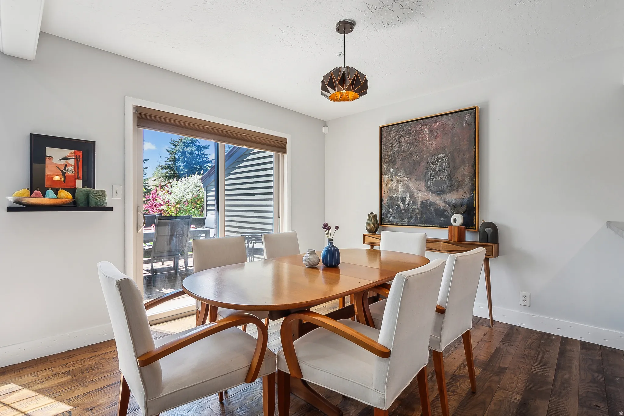 Dining area with wood-finish flooring and light gray walls