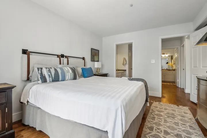 Bedroom featuring warm wood-finish flooring and light wall colors.  Bed is removed, call for details.