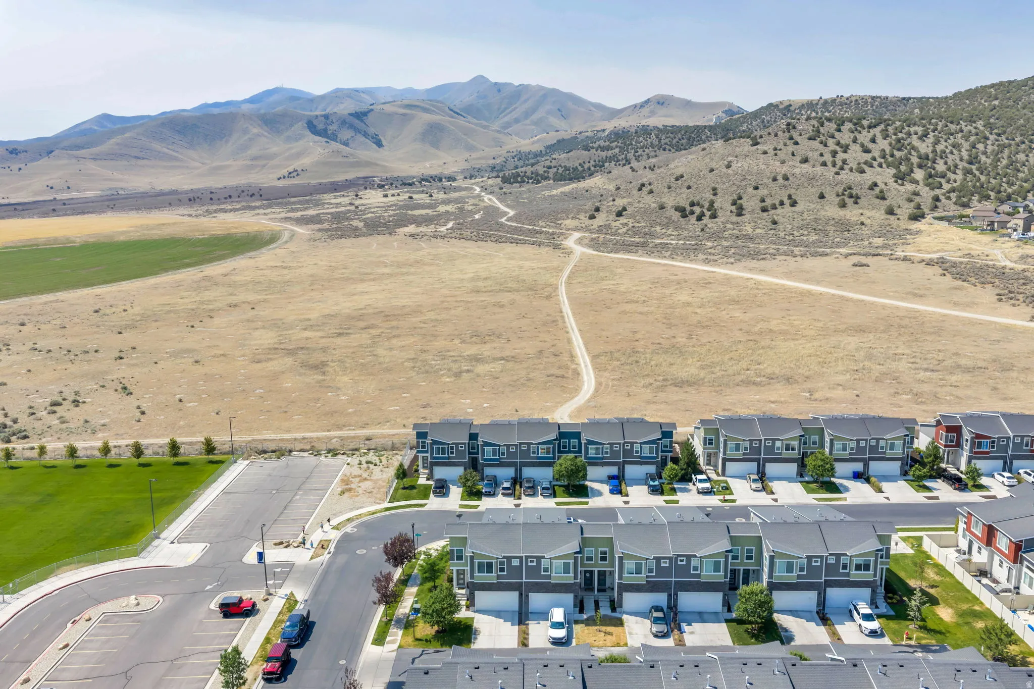 Near Open Spaces, Contemporary townhomes featuring multi-tone exteriors, individual garages, and paved driveways