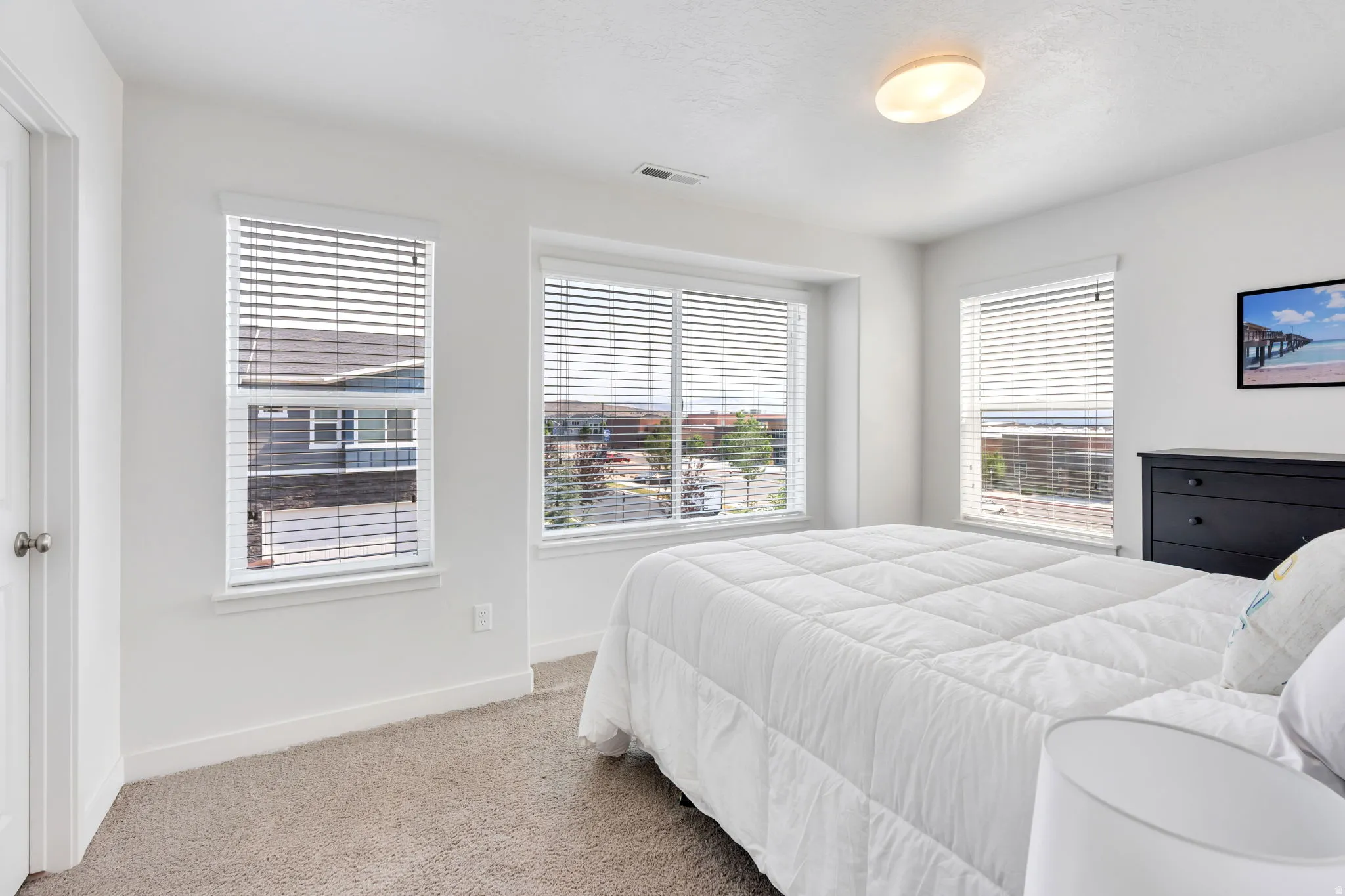 3rd Bedroom, with multiple windows, each featuring horizontal blinds