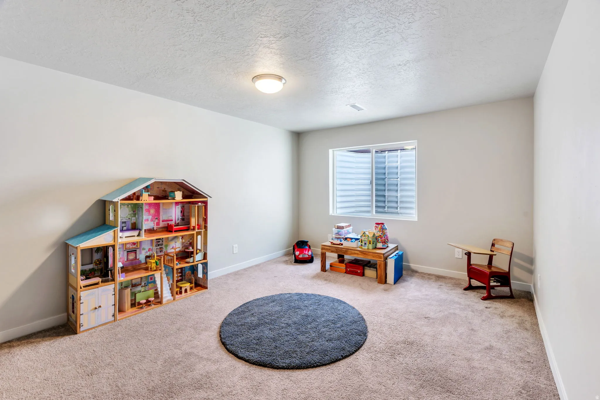 Large Family Room or Multipurpose Carpeted room featuring light-colored walls and a recessed window with horizontal blinds