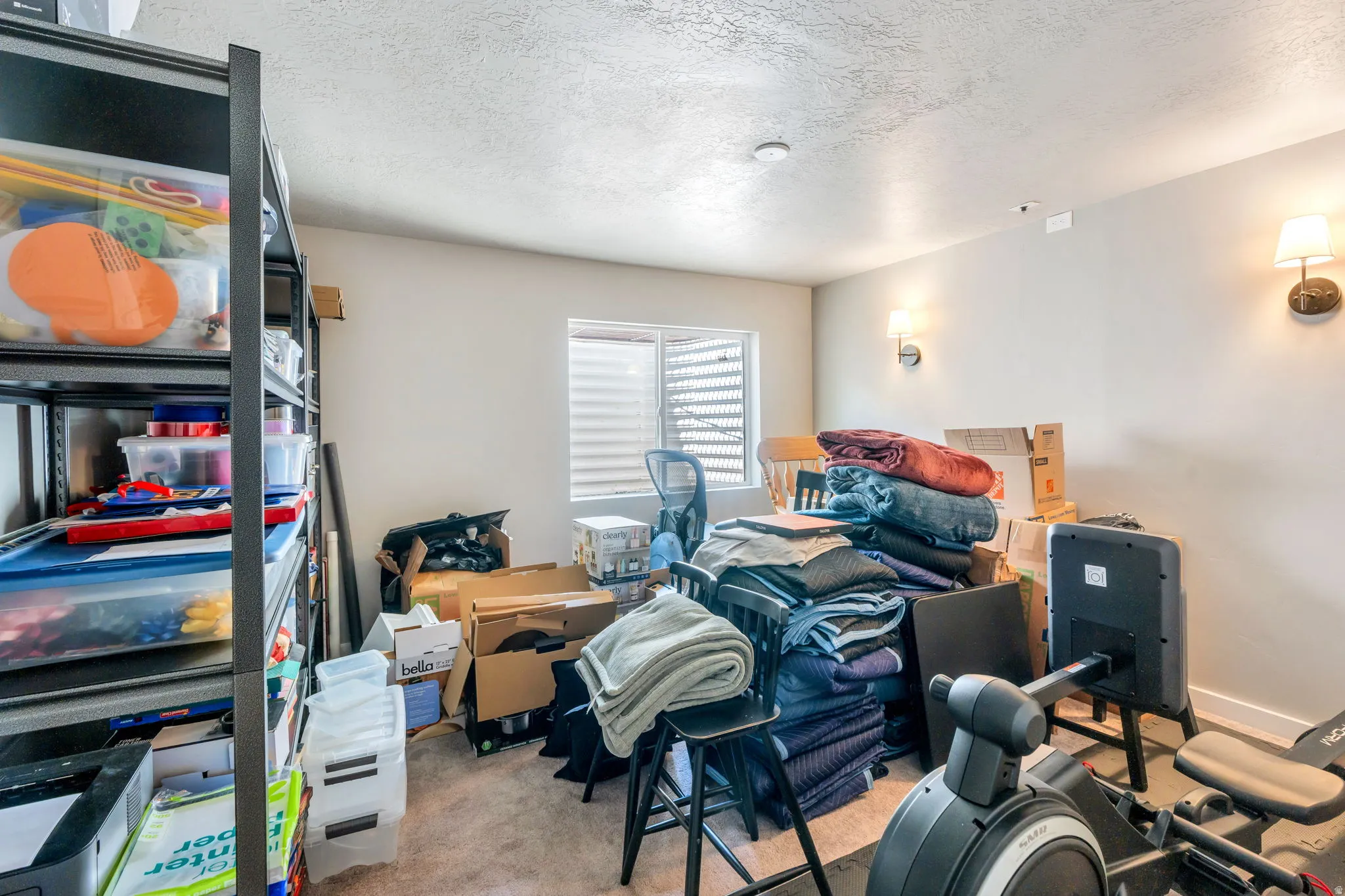 4th bedroom is in the basement.  Carpeted room with a single window featuring horizontal blinds
