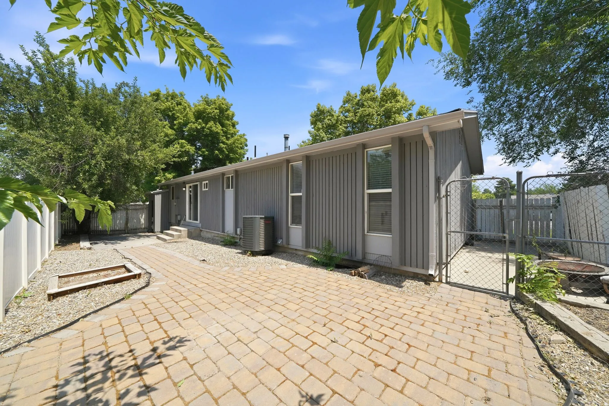 Exterior featuring vertical siding and a sloped roofline