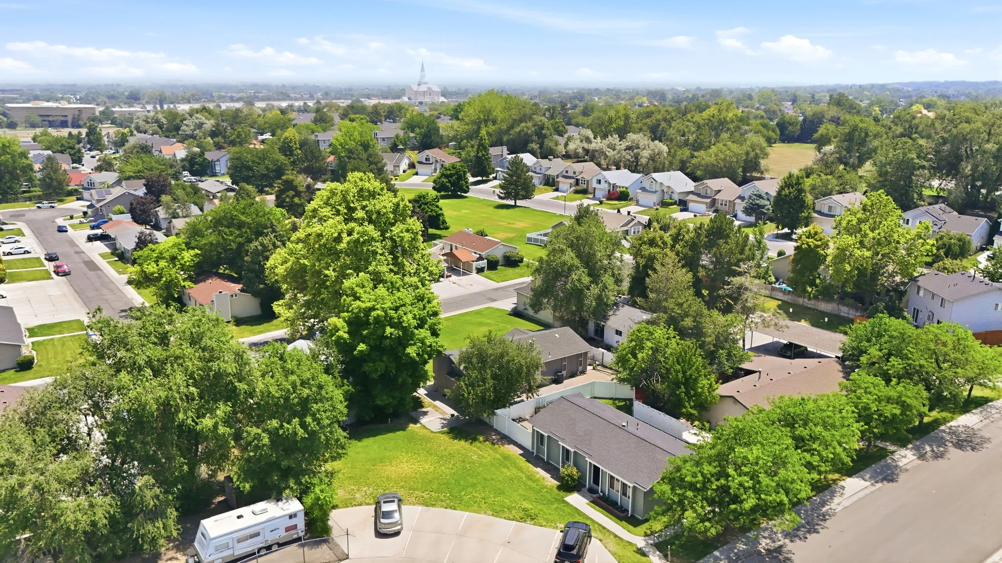 Aerial perspective showcasing a residential area with mature trees and established homes