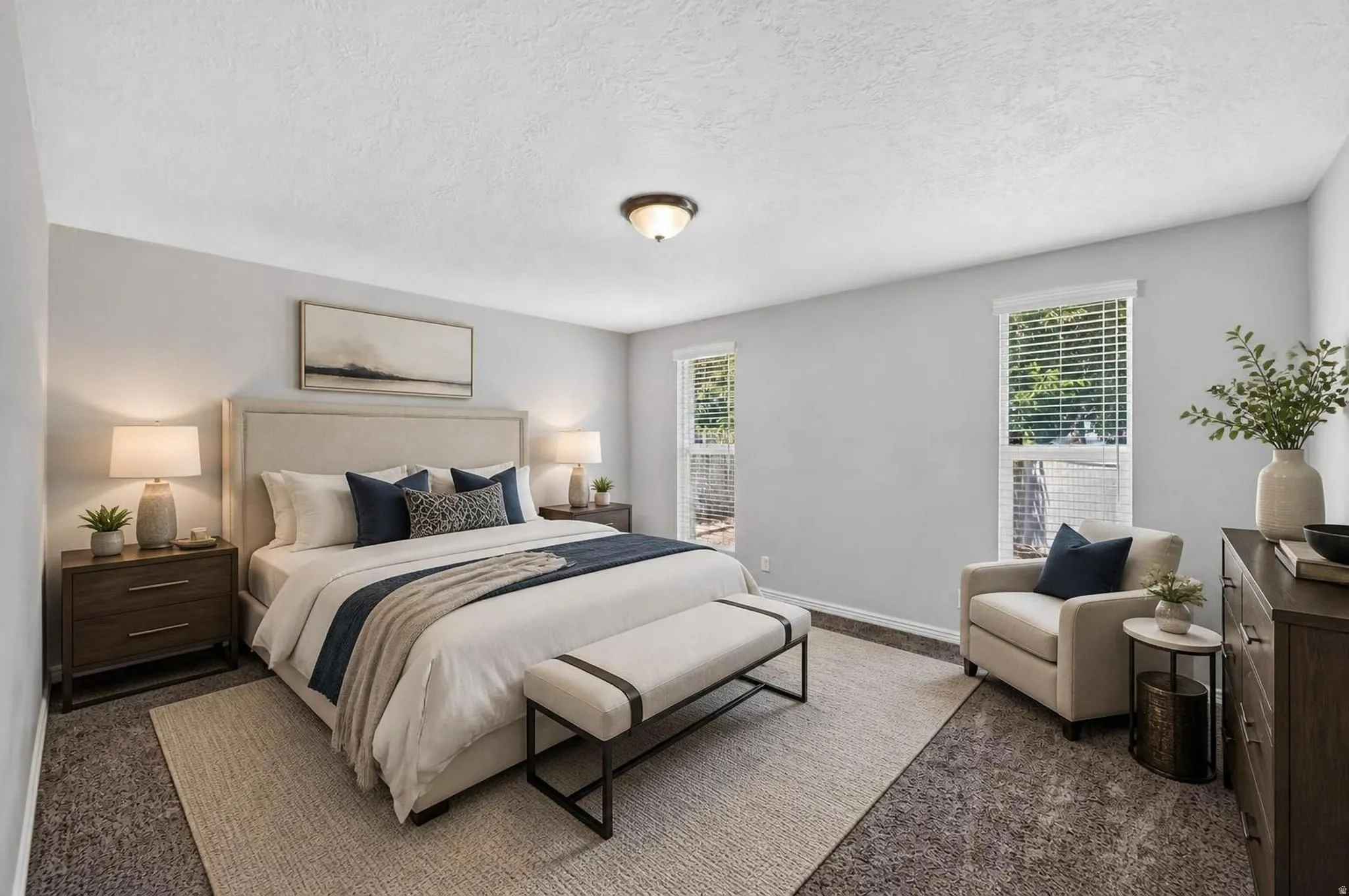 Spacious room featuring light gray wall paint, two windows with white blinds, wall-to-wall carpeting, and a semi-flush mount ceiling fixture