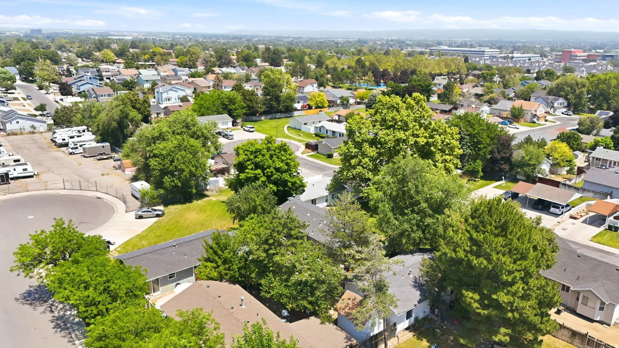Aerial perspective showcasing a residential area with varied housing styles and mature tree coverage