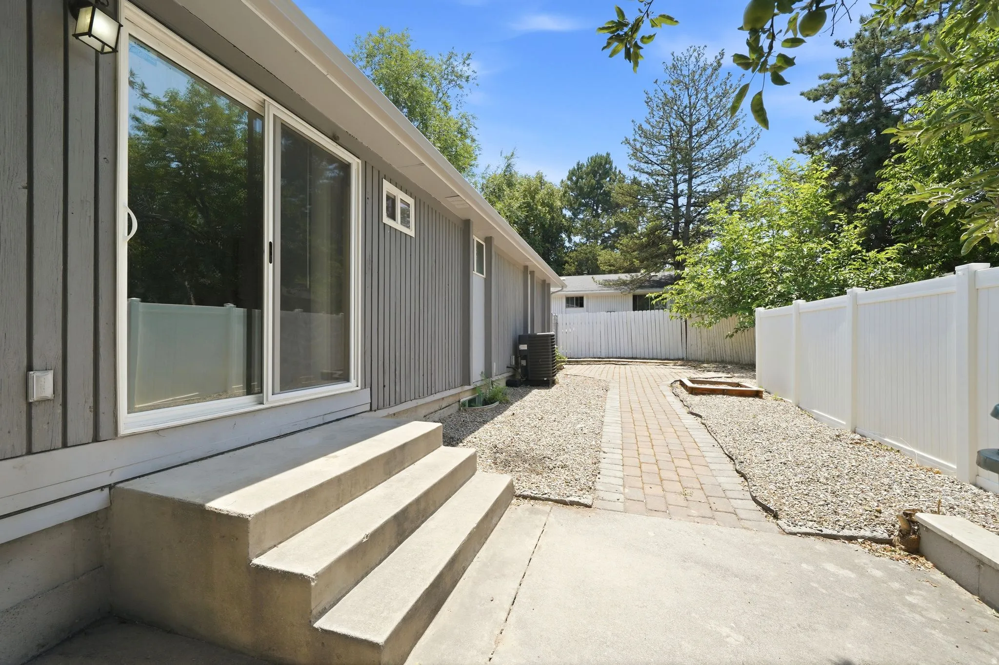 Concrete patio with steps leading to sliding glass doors