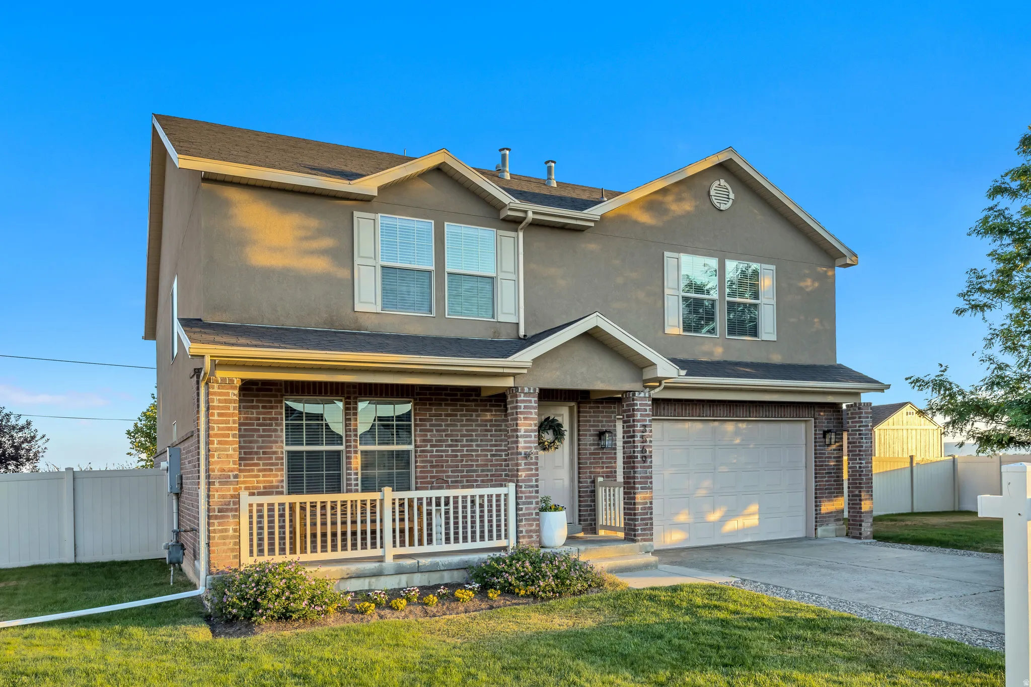 Two-story home featuring a combination of brick and stucco siding