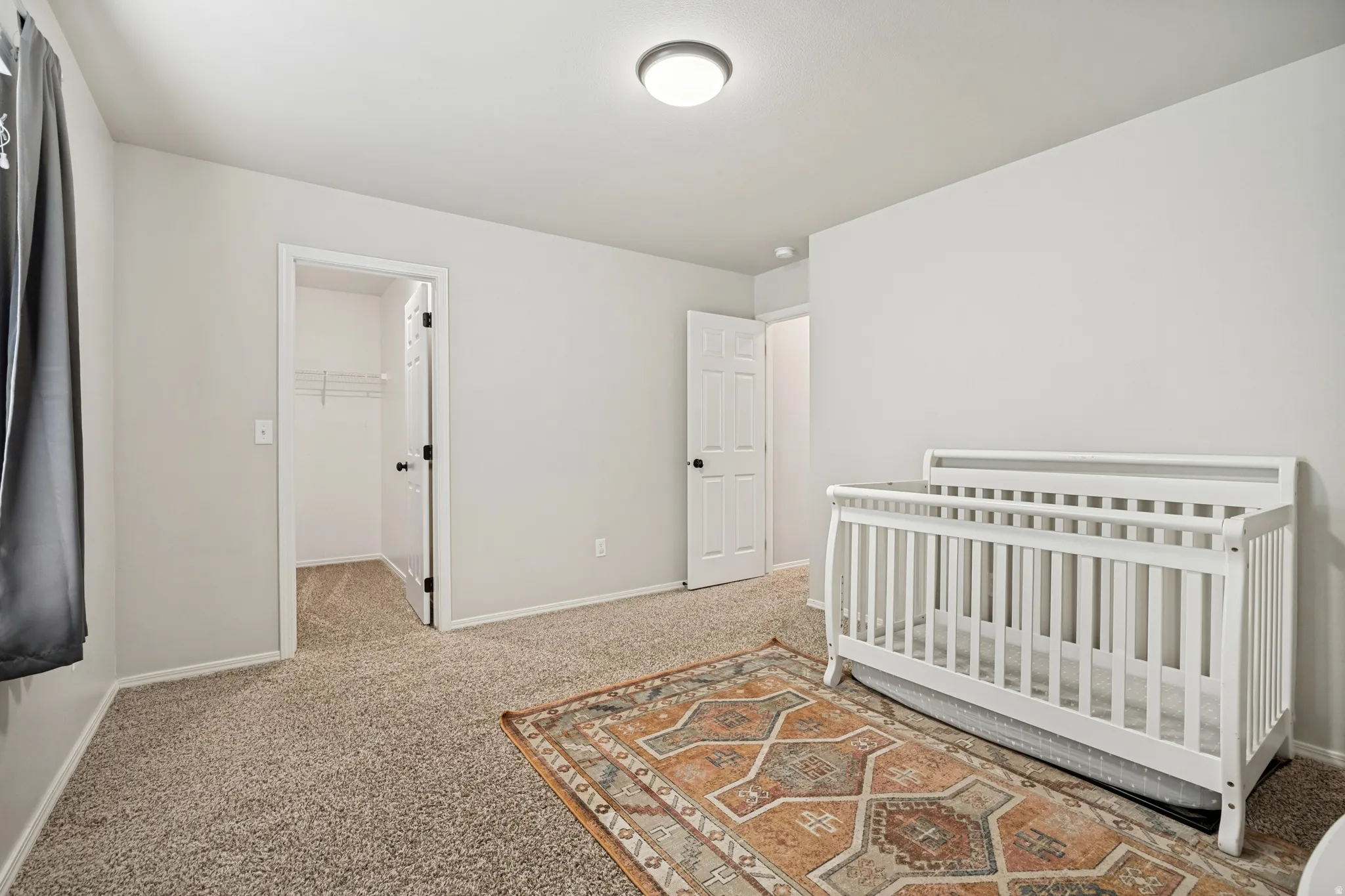 Neutral tone walls with textured carpeting throughout