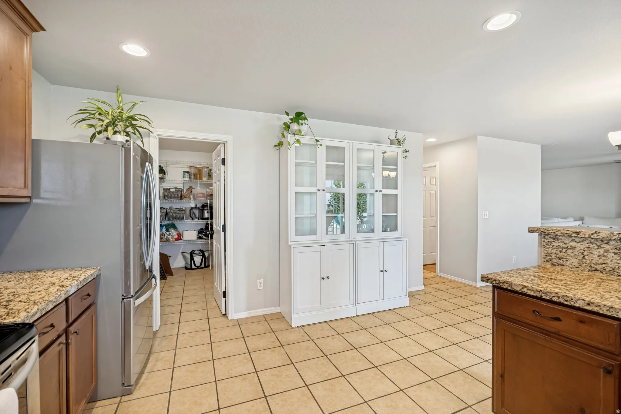 Kitchen featuring tile flooring, recessed lighting, and a built-in pantry with wire shelving