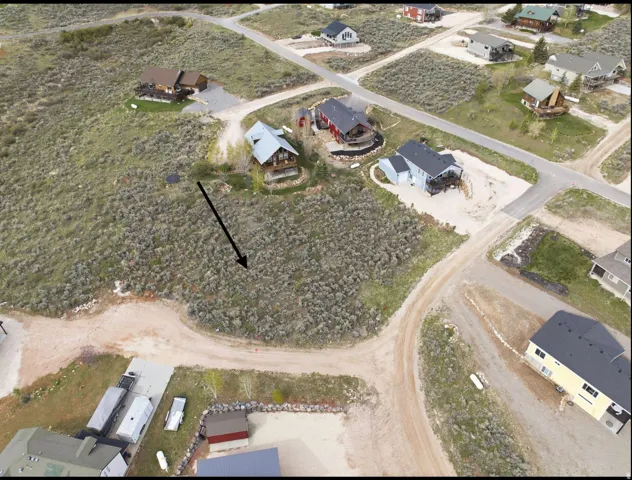 Aerial depiction of a spacious lot featuring natural, undeveloped terrain