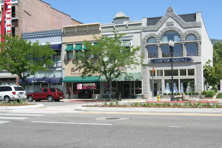 Commercial storefront featuring a stone façade with arched windows and a prominent display window