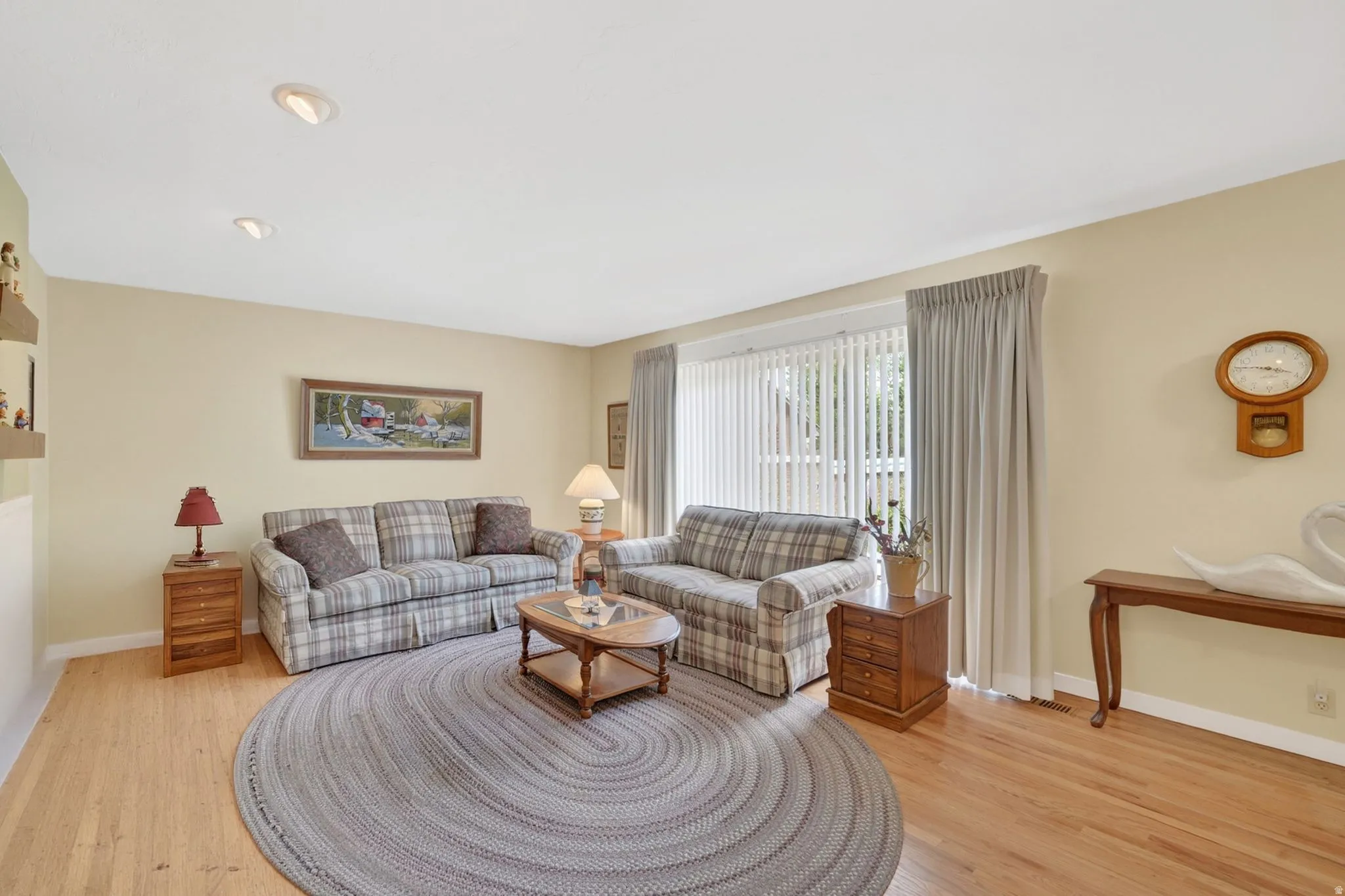 Living area featuring recessed lighting, light-toned walls, and wood-finish flooring
