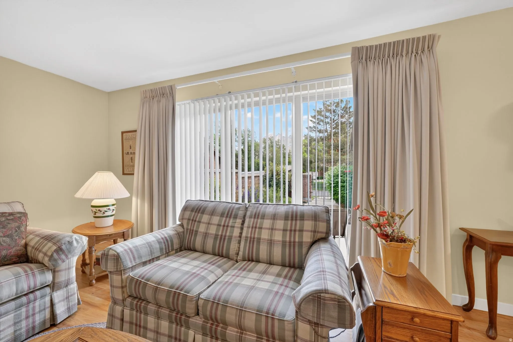 Sliding glass door with vertical blinds and floor-length curtains