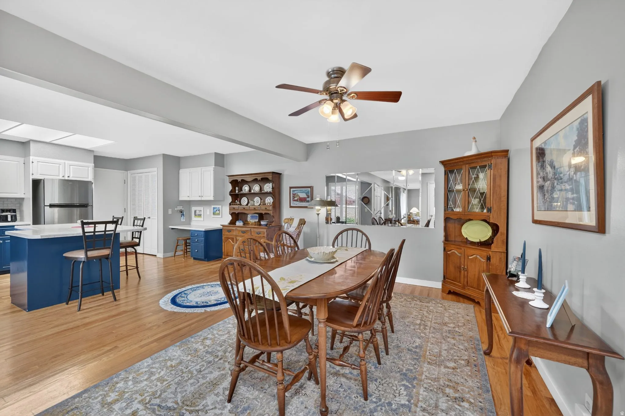 Dining area with wood-finish flooring and ceiling fan