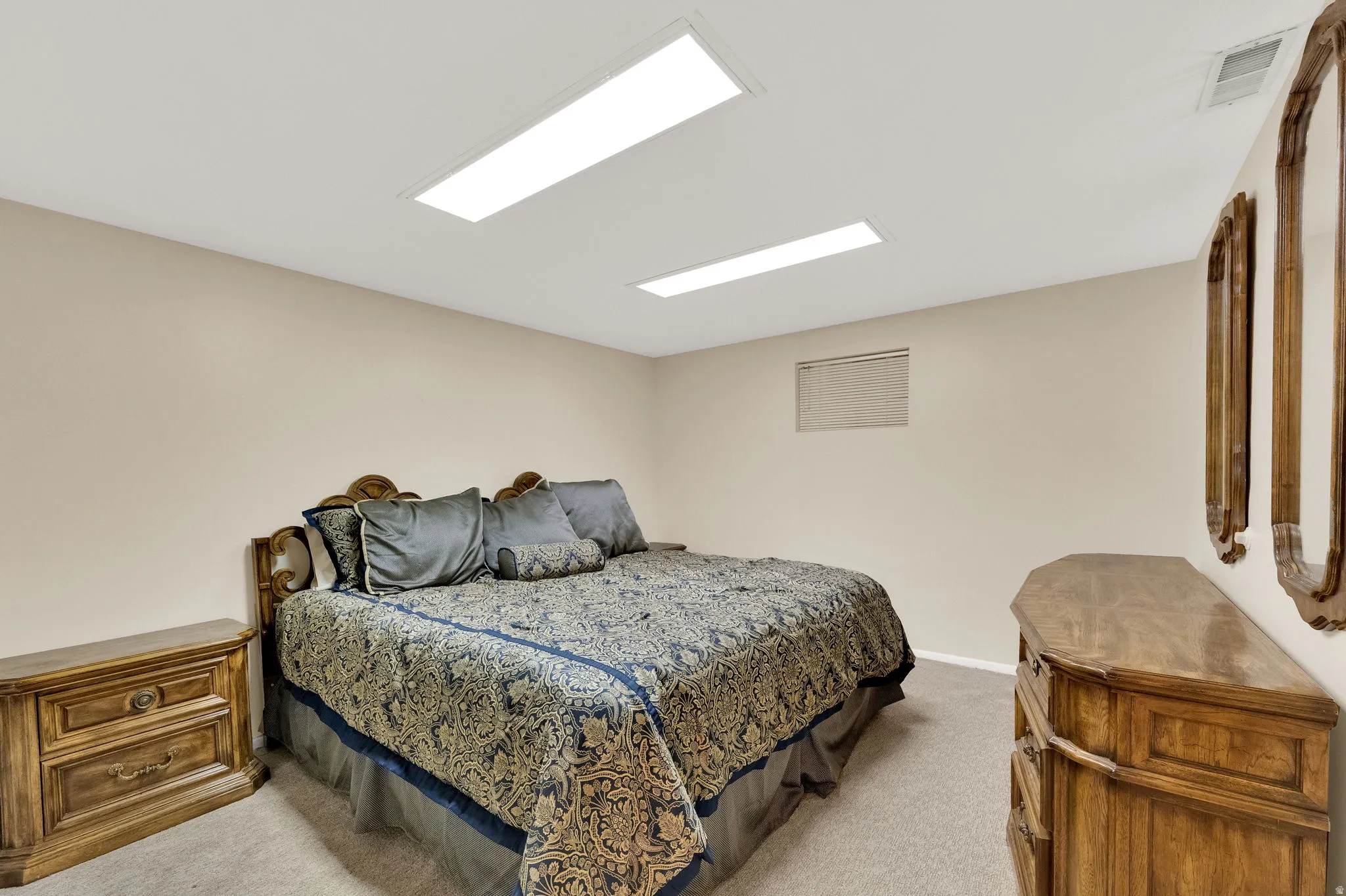 Carpeted room with recessed lighting and a single window opening
