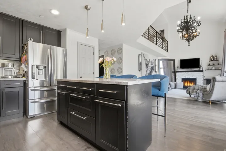 Open-concept living space with a kitchen island featuring a light-toned countertop