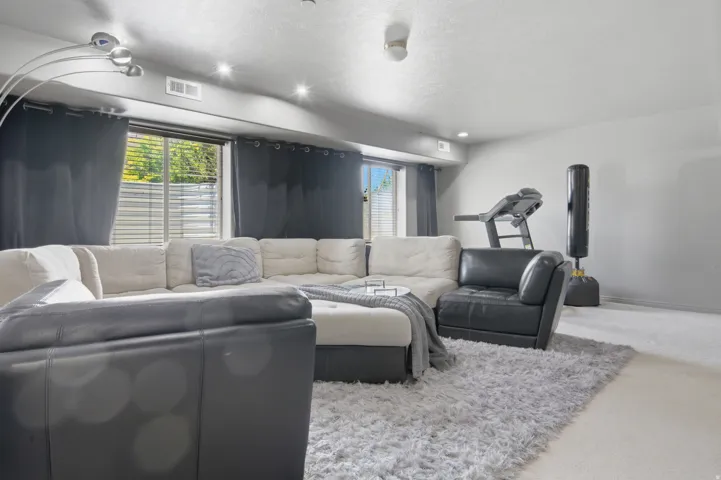 Spacious room featuring light-colored carpeting throughout