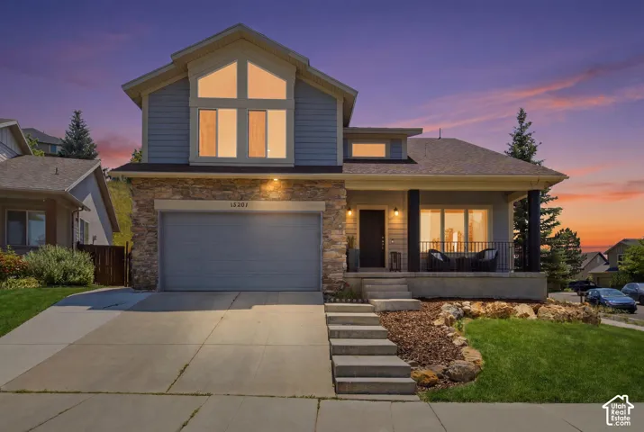 Contemporary exterior featuring light blue siding and stone veneer accents