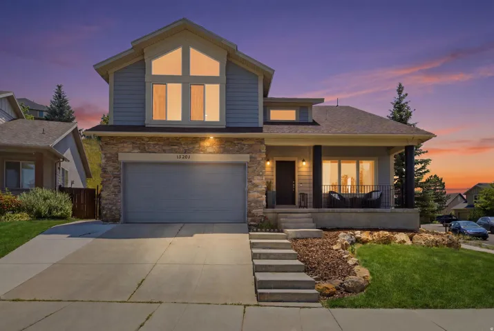 Contemporary exterior featuring light blue siding and stone veneer accents